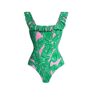 Detail of tropical green leaf print on pink one-piece swimsuit with ruffle trim