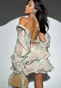 Detail of backless halter floral dress with layered ruffle hem and pink flower print