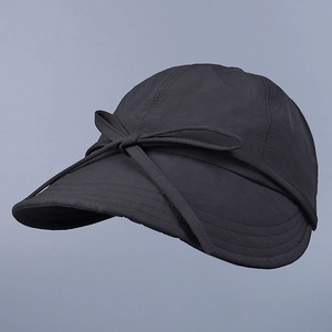 Detail view of a dark grey sun hat featuring a stylish sweet bow tie and nylon texture