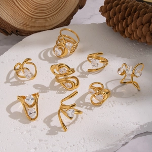 Collection of 18K gold plated stainless steel open rings with zircon stones on stone