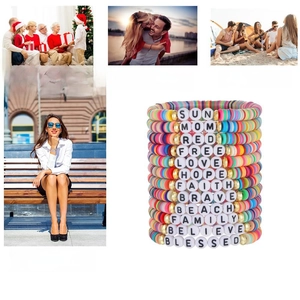 Stacked Taylor-style friendship bracelets with letter beads for family and friends
