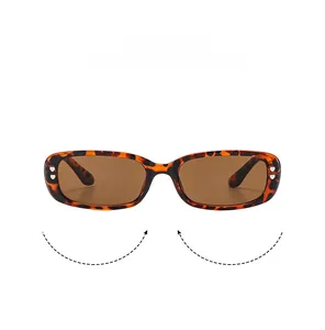 Close-up of retro tortoiseshell square sunglasses featuring twin silver heart-shaped studs