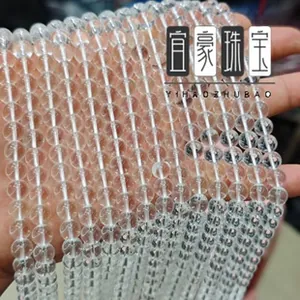 Macro view of transparent round quartz beads strung in multiple strands for DIY jewelry