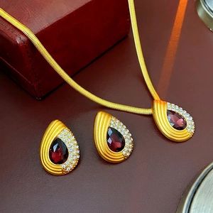 Vintage gold necklace and teardrop earring set with deep red stones and tiny diamonds