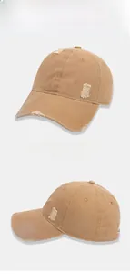 Detailed close-up of khaki distressed cotton baseball cap with vintage frayed edges