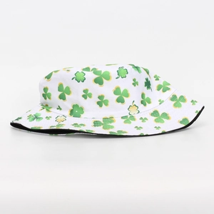 Macro view of white bucket hat with green shamrock clover prints for sun protection
