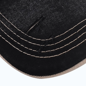 Close-up of baseball cap brim with triple khaki stitching and distressed edge detail