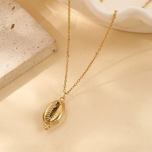 Close-up of vintage 18k gold plated conch shell pendant with realistic groove textures
