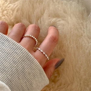 Minimalist 925 sterling silver beaded ring set with marquise cut stones on a model's hand