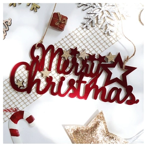 Close-up of sparkling red Merry Christmas sign with gold stars and festive holiday decor