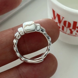 Macro view of 925 sterling silver croissant ring with adjustable open band design