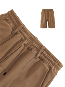 Close-up of brown casual shorts showing honeycomb texture fabric and drawstring waist