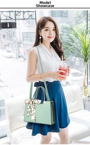 Pale green pebble leather handbag with scarf handle decoration and long shoulder strap