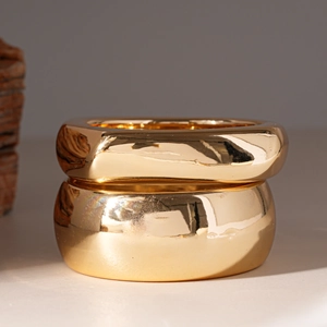 Set of two chunky gold-tone geometric acrylic rings with a polished mirror finish