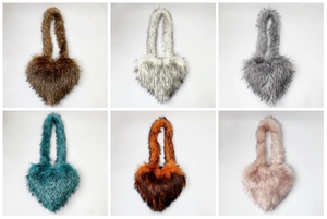 Detailed view of six faux raccoon fur heart bags in various colors with fluffy textures