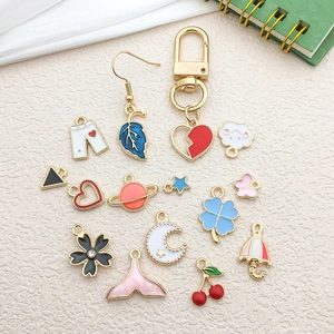 Golden enamel charms set with heart, clover, and flower shapes for jewelry making