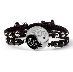Detail of Yin Yang Tai Chi bracelets with dragon totems and woven rope for couples