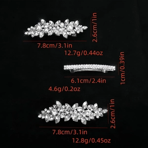Silver hair clips set with rhinestones and pearls showing sizes and weights on black