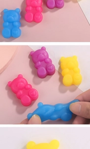 Close-up of hand stretching a colorful jelly bear squishy toy for stress relief