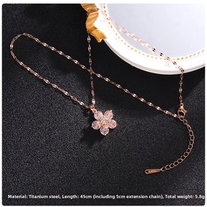 Macro detail of rose gold spinning clover necklace with zircon and O-chain sequins