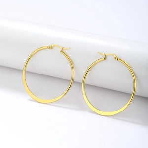 Polished gold large hoop earrings in minimalist stainless steel for women on white background