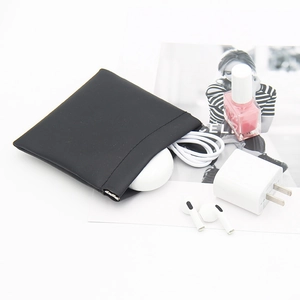 Compact black matte faux leather pouch with shrapnel closure for digital accessories
