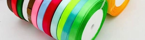 Macro shot of colorful 1cm satin ribbon rolls for gift wrapping and DIY crafts