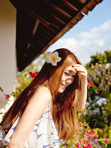 Close-up of white plumeria flower hair clip for summer vacation seaside hairstyles