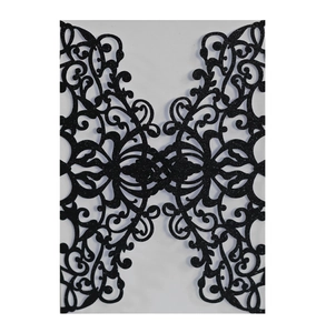 Detailed laser-cut pattern of a dark blue glitter wedding invitation card