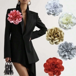 Oversized satin flower brooch and hair clip set in various colors shown on suit lapel