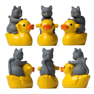 Miniature gray cat figurine riding a yellow rubber duck from multiple views