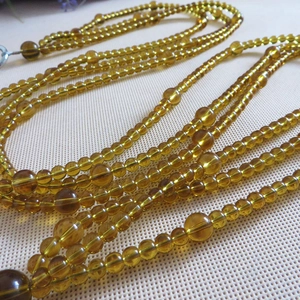 Close-up of amber crystal bead chain strap with transparent resin beads for handbags