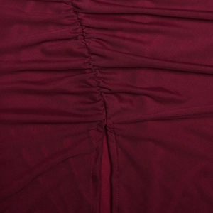 Macro shot of burgundy mesh fabric with detailed ruching and stitching for evening dress
