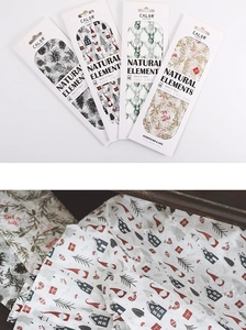 Detailed view of Christmas themed tissue paper with Nordic natural elements and floral patterns
