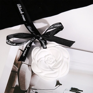 White rose shaped plaster aromatherapy sachet with black ribbon for wardrobe fragrance