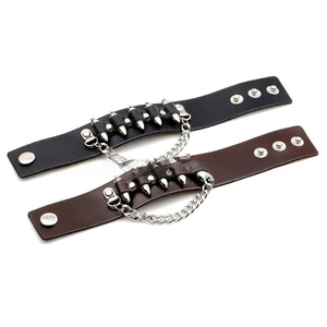 Detail of leather punk bracelets featuring silver spikes and metal chain accents
