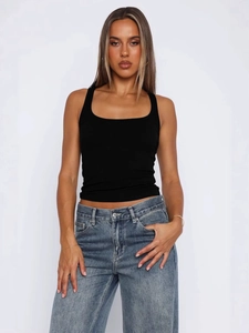 Y2K style black ribbed knit tank top vest for women paired with blue jeans