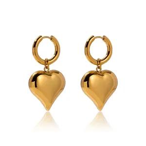 Detail of gold heart pendant earrings with measurements 4.23cm height and 2.3cm width