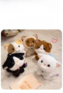 Close-up of five colorful plush cat keychains with ribbon bows and metal bells