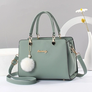 Street style green faux leather tote bag with plush pompom and detachable strap