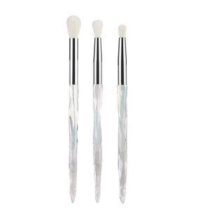 Detailed view of iridescent crystal handle makeup brushes with white soft bristles
