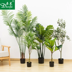 Collection of artificial indoor plants including monstera and olive tree in black pots