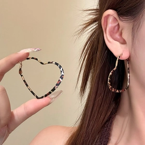 Vintage leopard heart hoop earrings with gold metal edges for a bold fashion statement