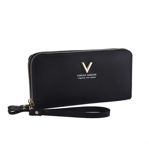 Close-up of black litchi leather wallet with gold V-decoration and dual zippers