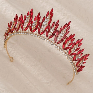 Detail of vintage crown featuring red marquise crystals and clear rhinestones on gold alloy