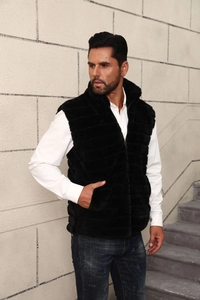 Close-up of black faux fur vest with stand collar on a male model outdoors