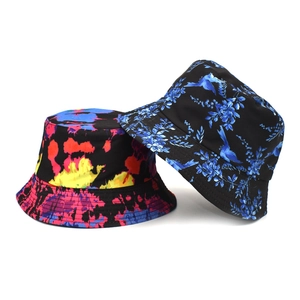 Outdoor bucket hats featuring vibrant tie-dye and blue floral prints on a white background