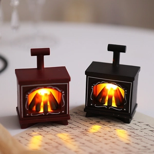 Detail view of mini LED electric fireplace lanterns with warm glowing faux log effects