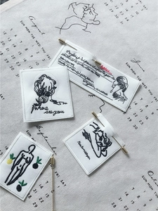 Artistic set of four embroidered fabric patches with minimalist black line female sketches