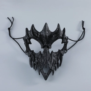 Close-up of black gothic half-face mask with bone textures and sharp fangs